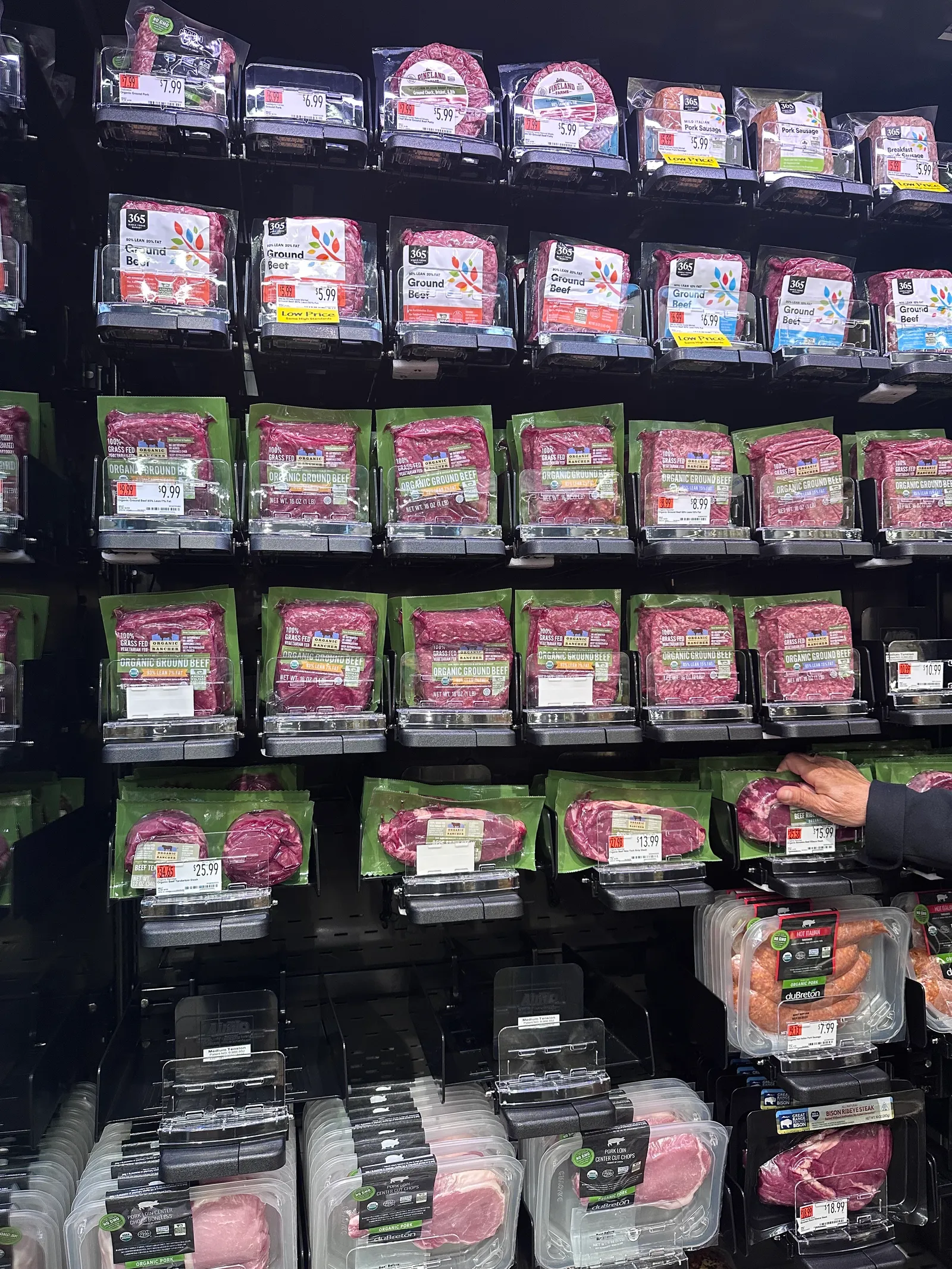 Display of pre-packaged raw meat cuts at a grocery store