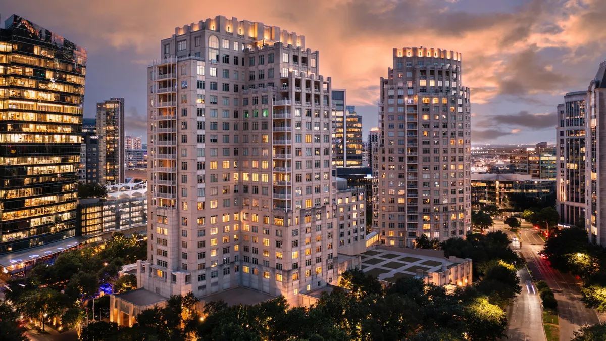 A building at twilight in the middle of the city.