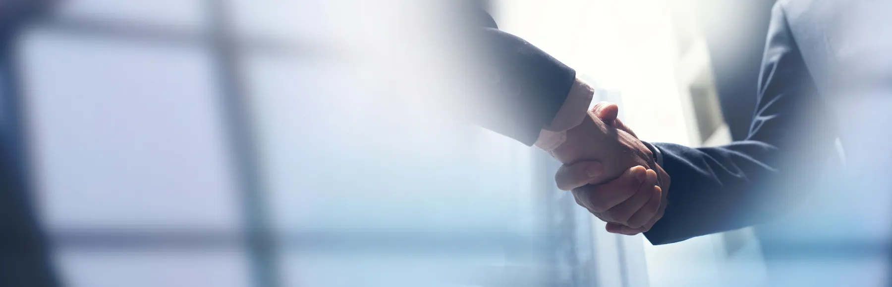 Two people shake hands in a stock photo.