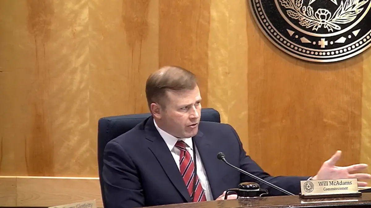 Texas PUC Commissioner Will McAdams speaks at an open meeting Thursday, Dec. 14, 2023.