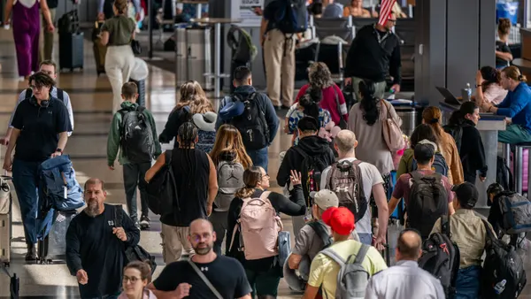 A crowd of travelers in a busy airport.
