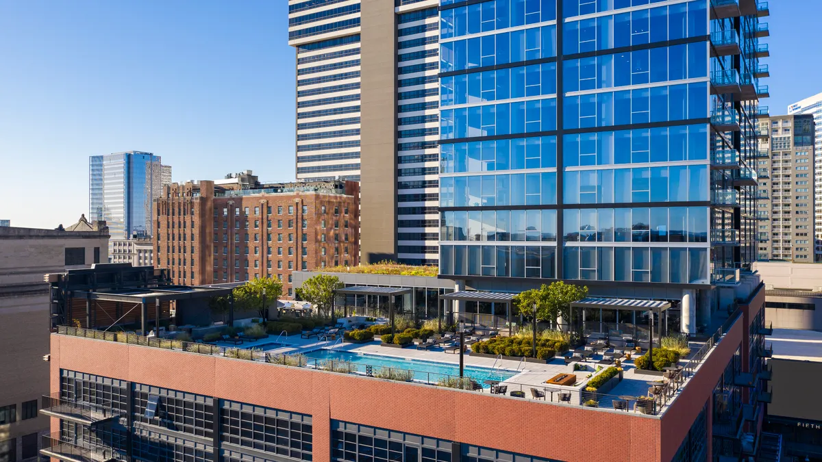 A modern apartment building against a city skyline.