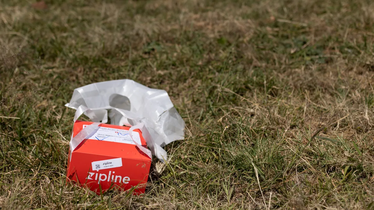 A Zipline delivery package resting on grass