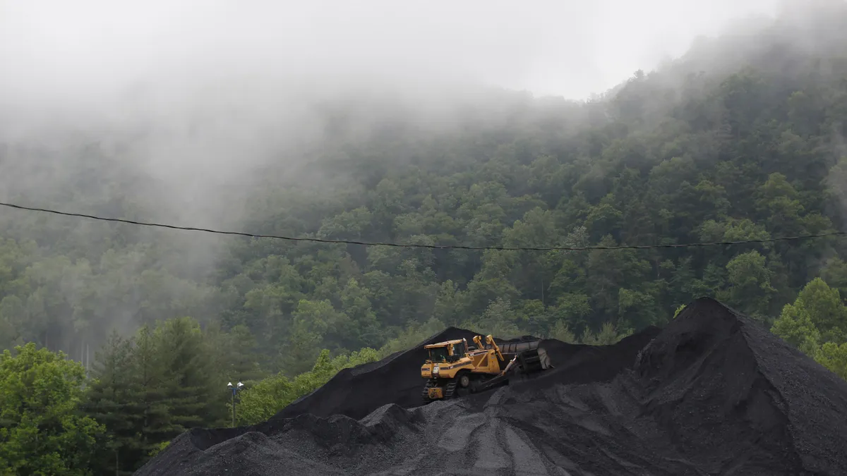 A bulldozer operates atop a coal mound at the CCI Energy Slones Branch Terminal June 3, 2014 in Shelbiana, Kentucky.