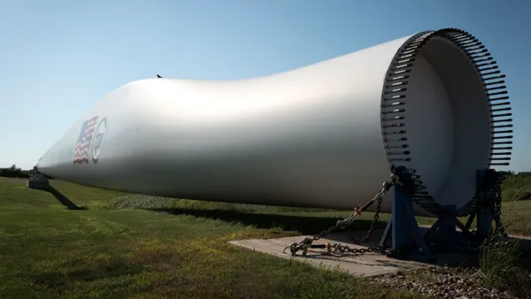 A composite wind blade, used in the construction of power-generating wind turbines, displayed outside