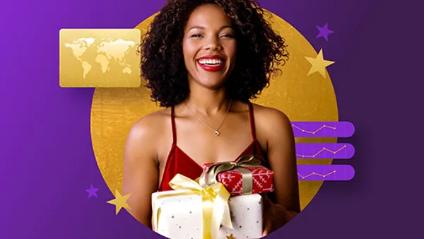 A person holding a gift box and smiling