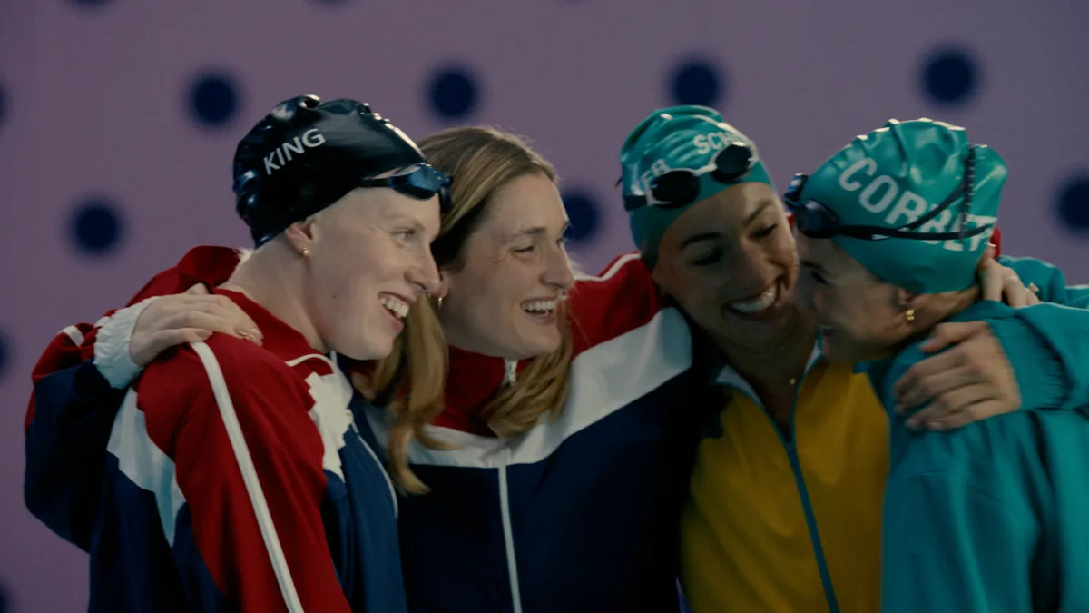 Four athletes embrace in a Coca-Cola Olympics ad