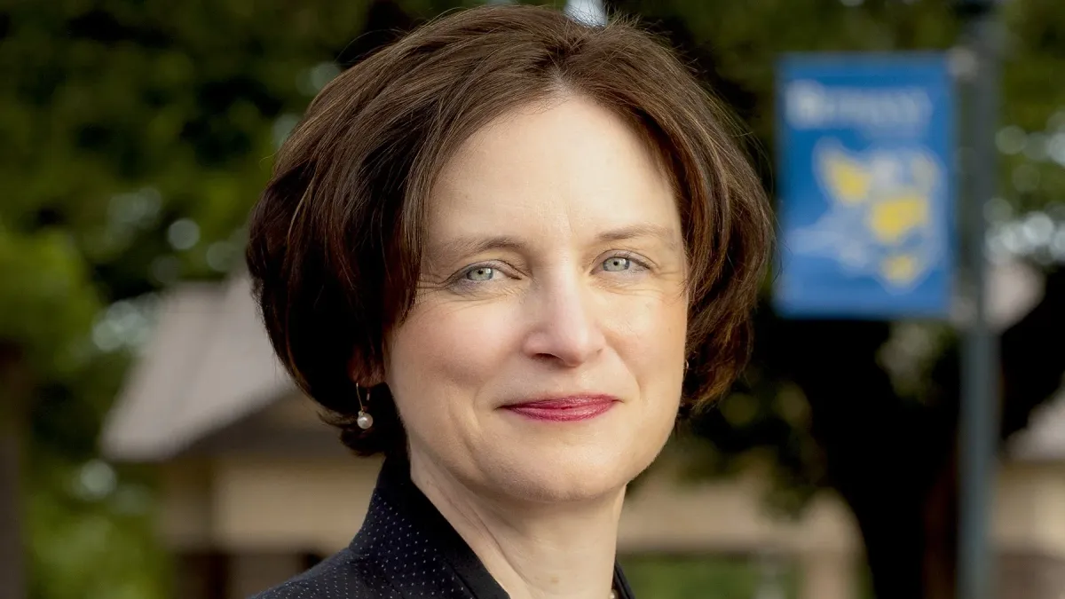 A headshot of Elizabeth Mauch, a White woman with brown hair wearing a black blazer.