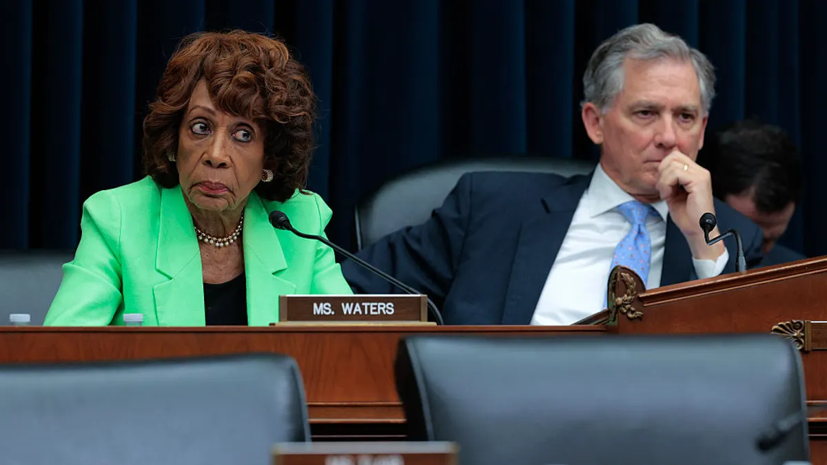 Two representatives in business attire at a hearing.