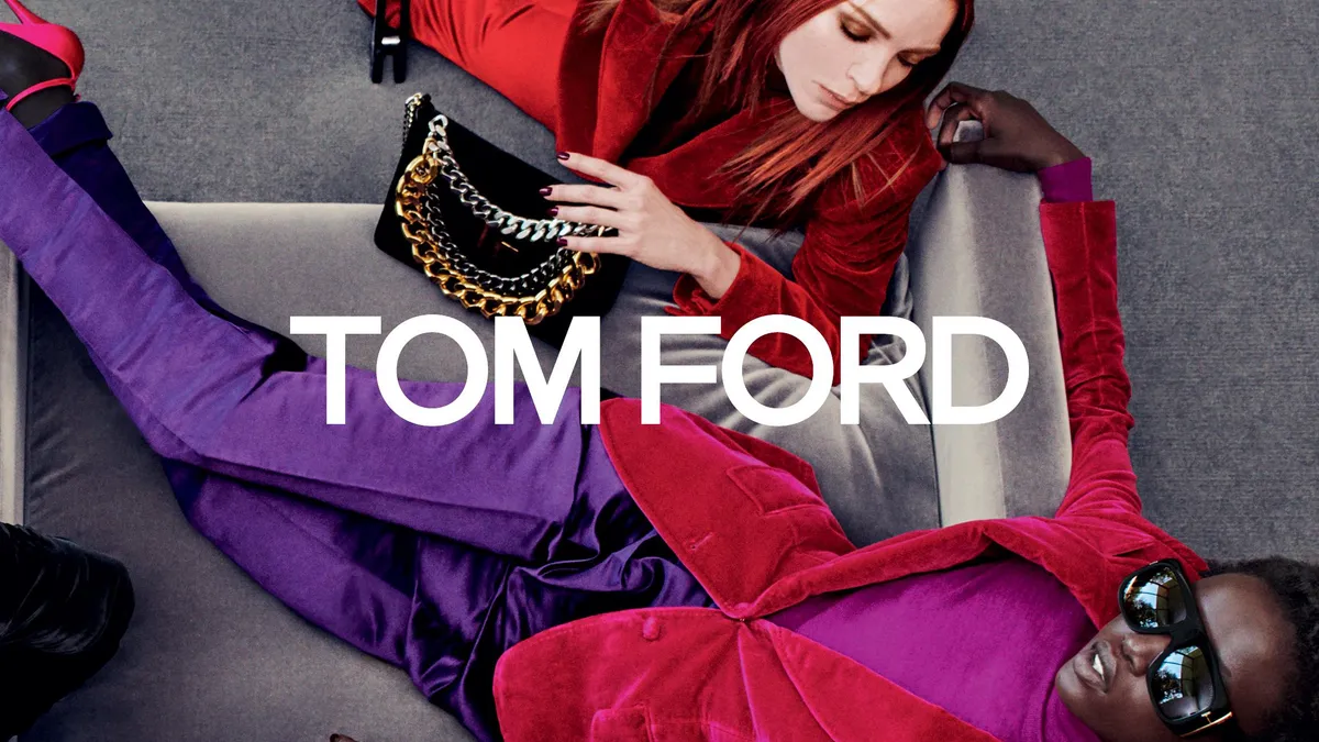 Models wearing red jackets, one above holding a black handbag with a chain, another below wearing sunglasses and purple pants, surround the name "Tom Ford" in white letters.