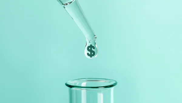 A clear drop with a dollar symbol is pipetted into a test tube.