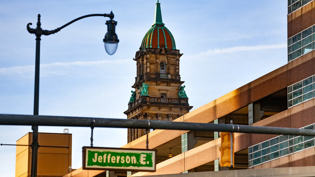Sign reading " E Jefferson" against backdrop of buildings in Detroit.
