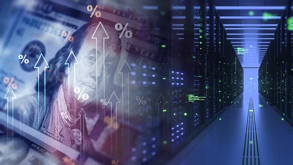 A graphic image of a $100 dollar bill with the US flag overlayed over it and some computer servers in the background.
