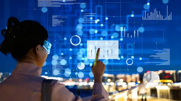 Smart city concept: businesswoman interacting with artificial intelligence data interface at night