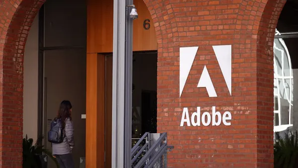 an exterior shot of a brick building with Adobe logo in white letters