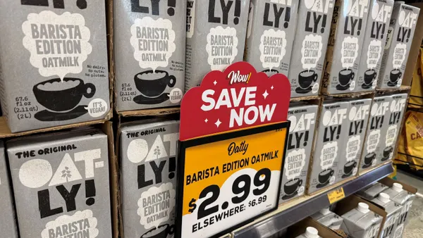 Close-up of a sign for a deal on oat milk.