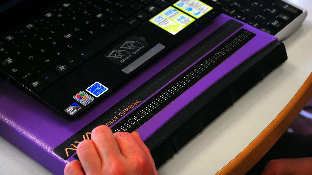 A student uses a refreshable braille display.