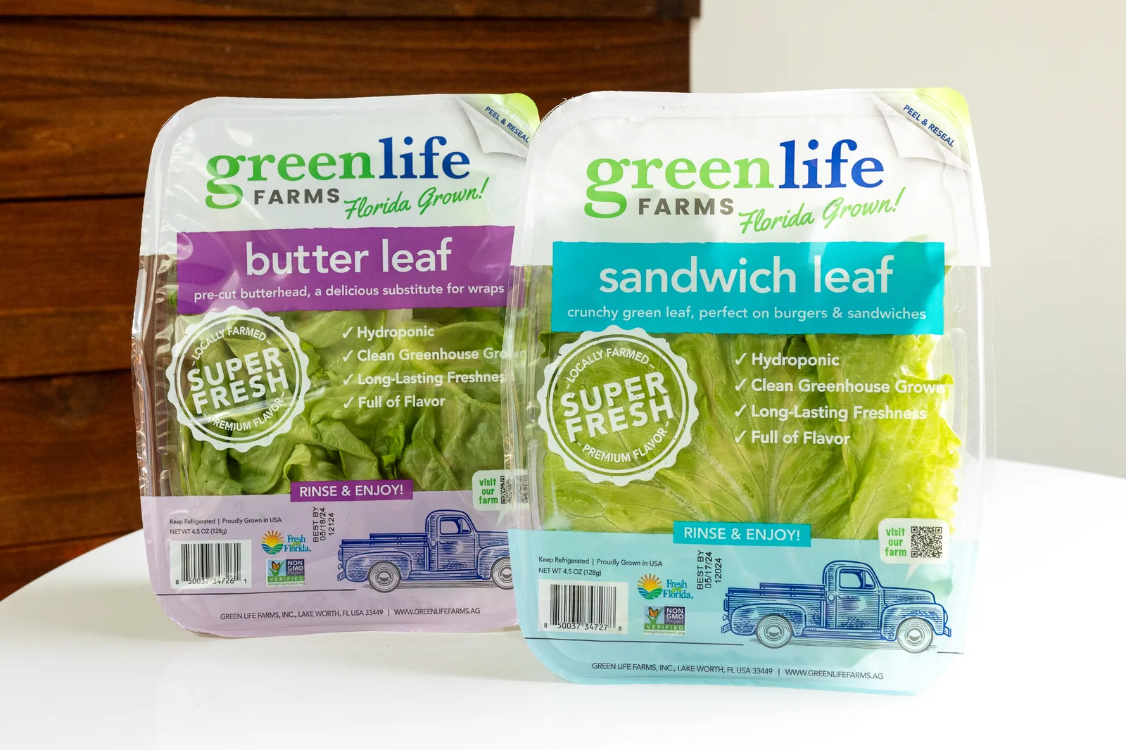 Two transparent plastic containers of Green Life Farms lettuce.