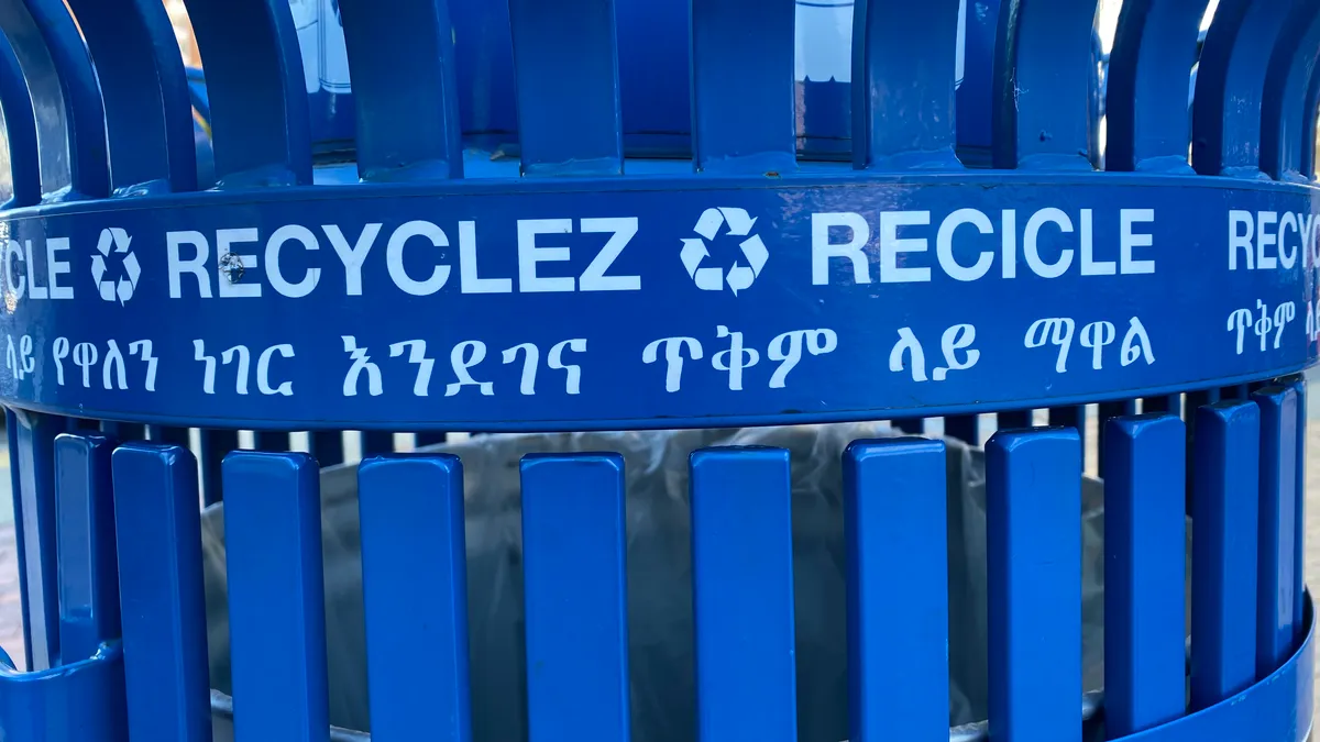 A close up of a recycling bin labeled in multiple languages