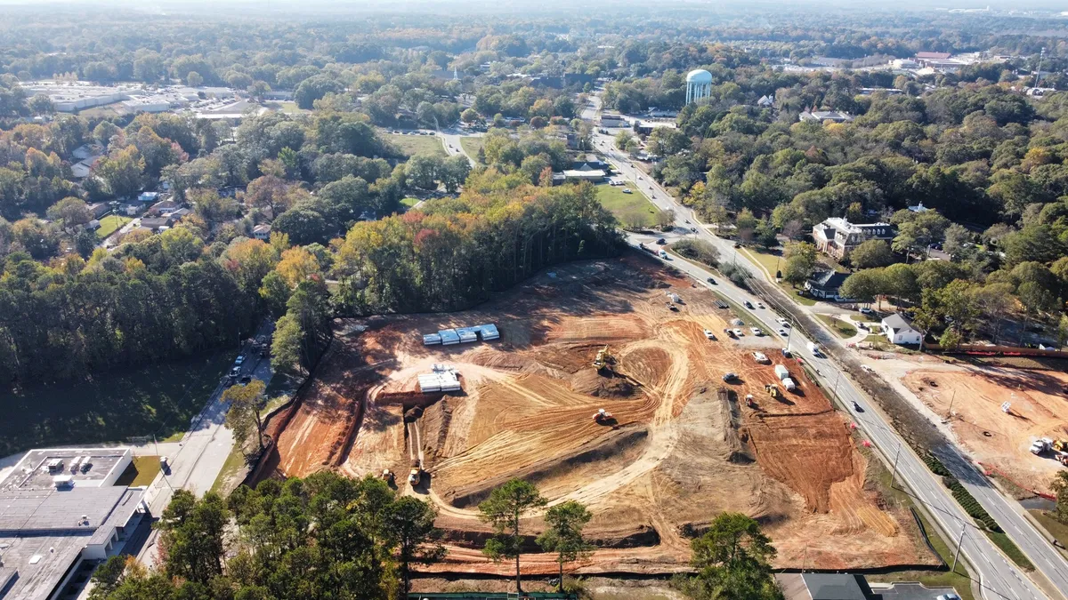 A construction site nestled within trees.