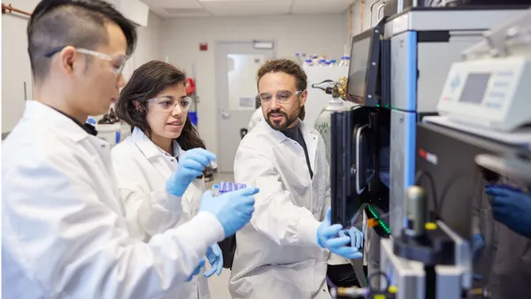 Three people work in Empress Therapeutics' lab.