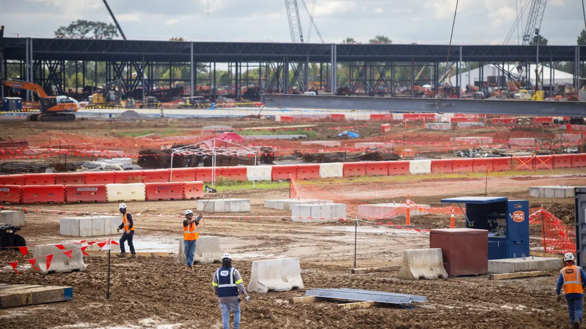 Construction workers at an industrial site.