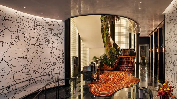 The lobby features an orange carpet with a modern design.