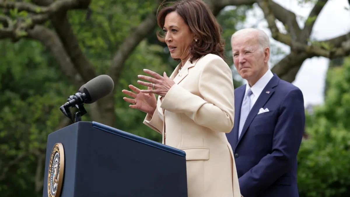 Kamala Harris speaking alongside President Biden at a podium