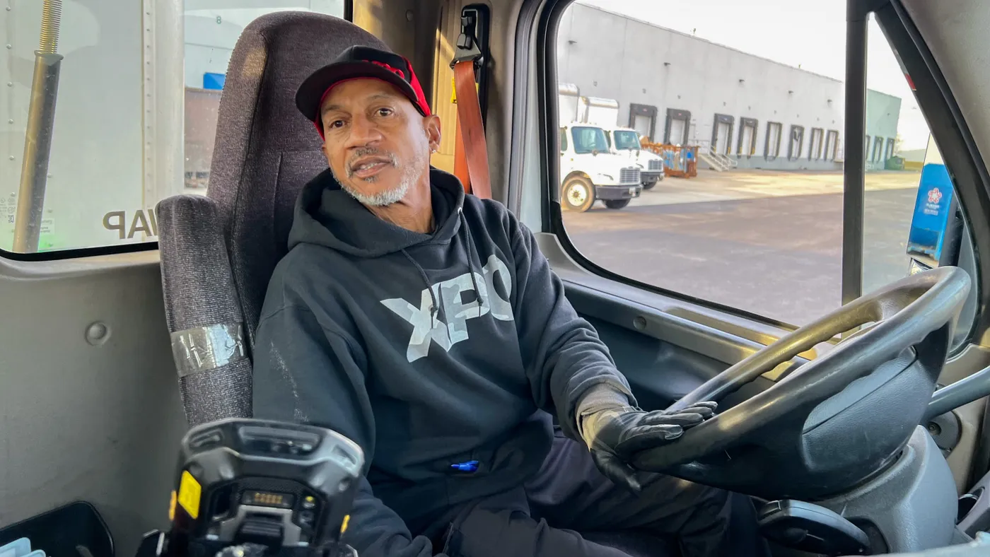 XPO driver Steadman "Steve" Mitchell reverses his truck toward a loading dock at a customer facility in Maryland on Feb. 27, 2024.