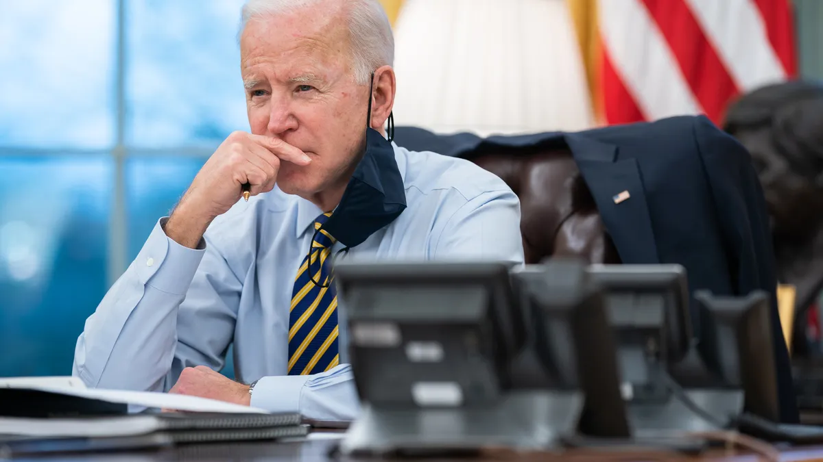 President Joe Biden participates in a conference phone call with governors affected by a snowstorm in the Midwest and southwest Tuesday, Feb. 16, 2021, in the Oval Office of the White House.