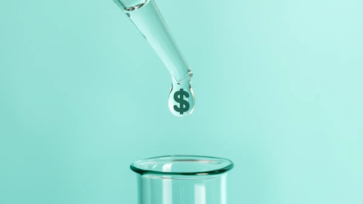 A clear drop with a dollar symbol is pipetted into a test tube.