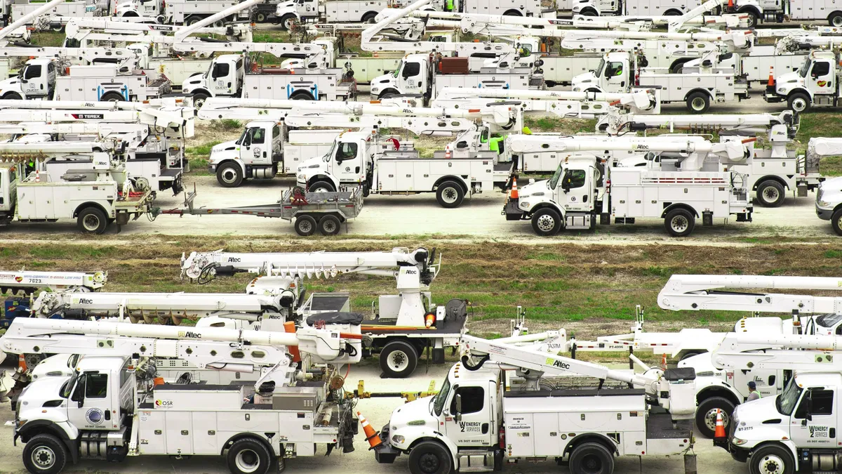 Rows of electric utility trucks.