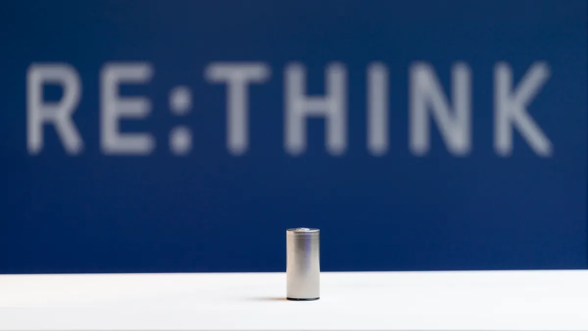 A lithium-ion battery posed in front of a blue background.