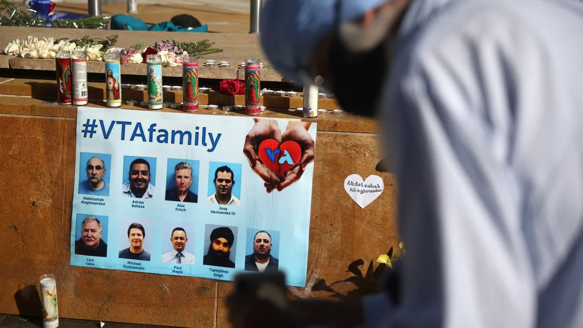 A mourner pauses in front of a memorial for the nine victims of a shooting.