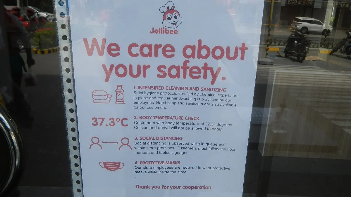 A sign at a Jollibee explaining new safety and cleaning protocols in place