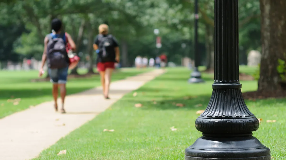 Students walking on campus during the summer