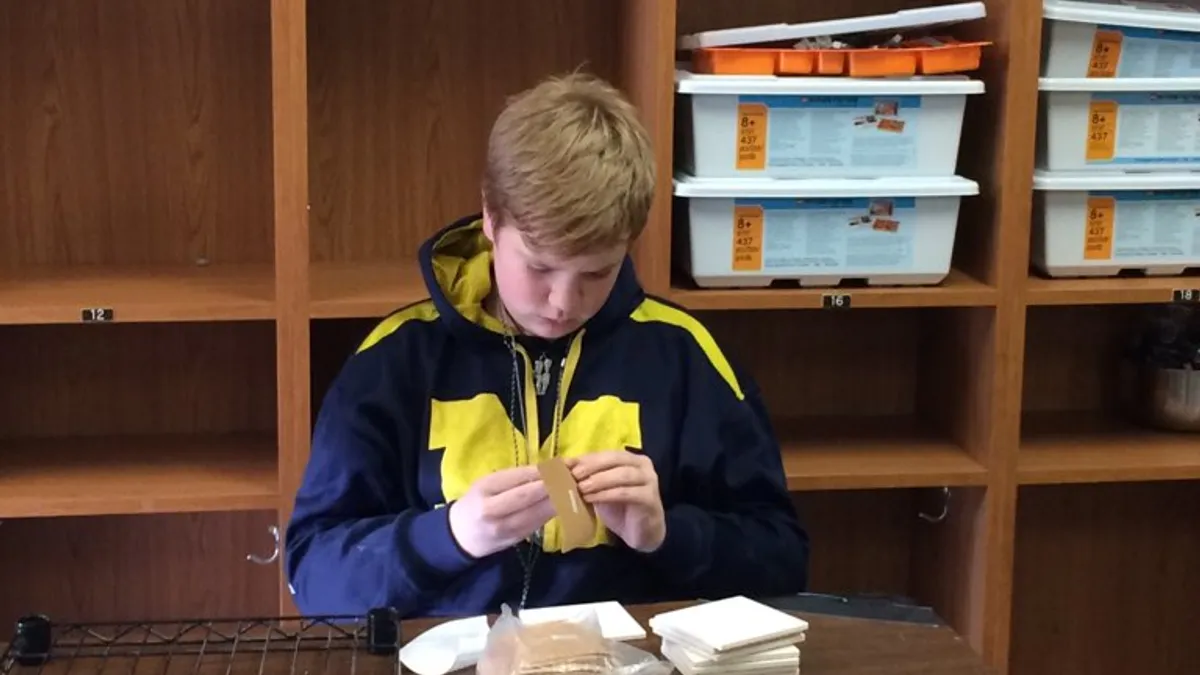 A student at Dacusville Middle School in Easley, South Carolina prepares orders during the 2019-20 school year for Goldwave Graphics, a design graphics company run by students.