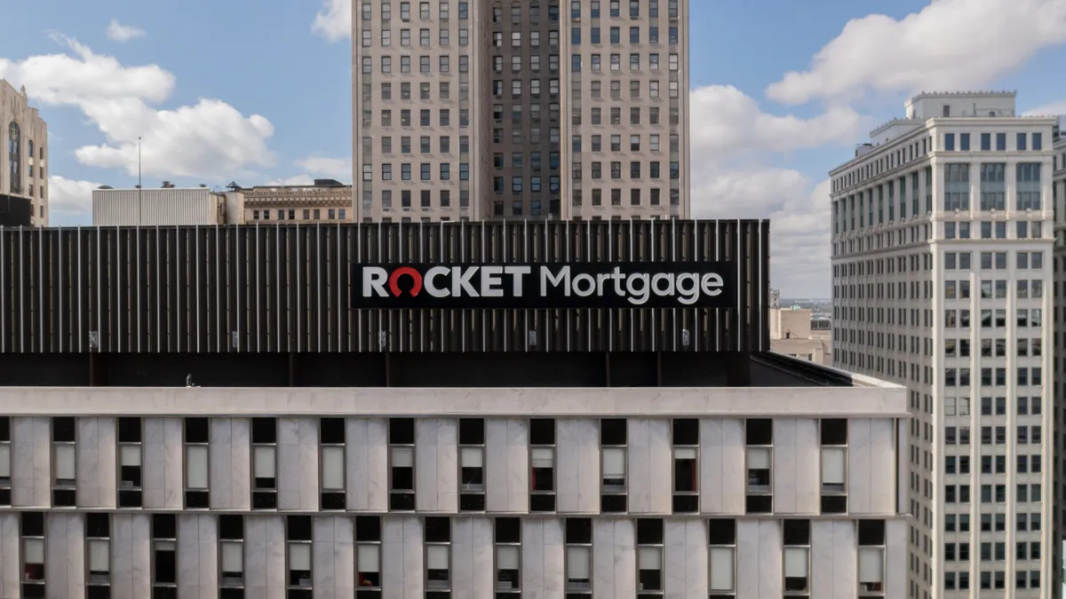 The Rocket Mortgage logo is seen atop a large office building in the downtown core of a city.