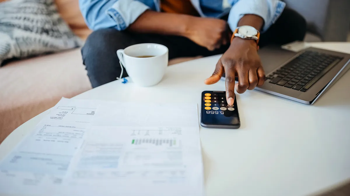 Unrecognisable man going over his finances.