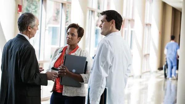 Hospital lobby C-Suite meeting with Doctor