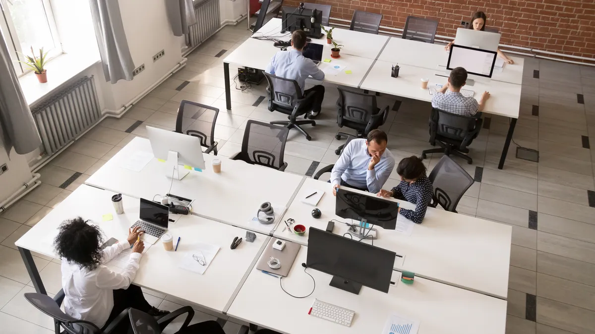 Employees working together in modern open office space