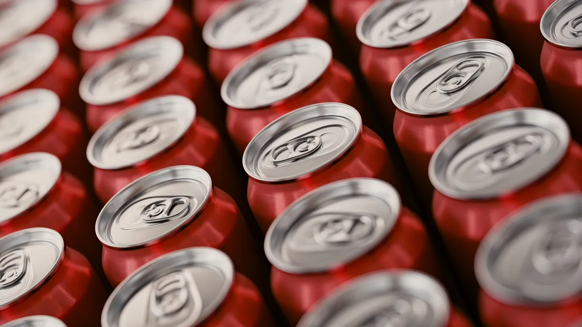 The tops of cans of Coca-Cola