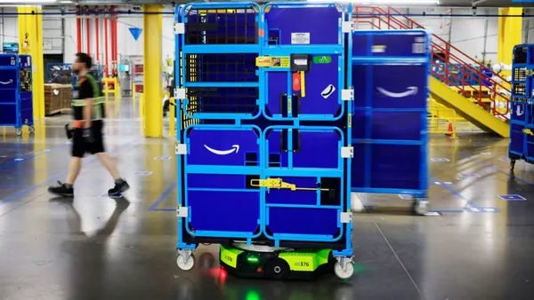 Amazon warehouse robot Proteus carries a tote inside a company facility.