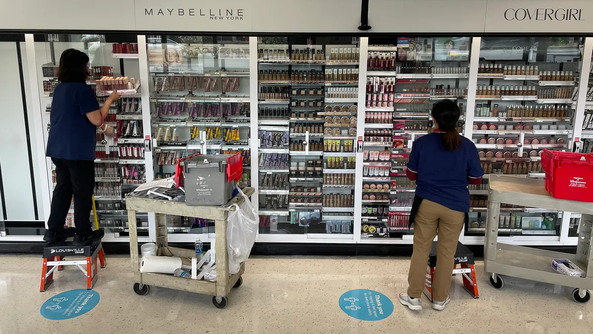 Store workers in the beauty section of a store.