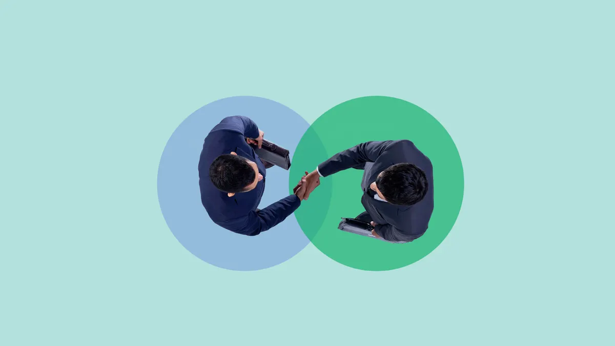 Two business partners shaking hands after successful deal