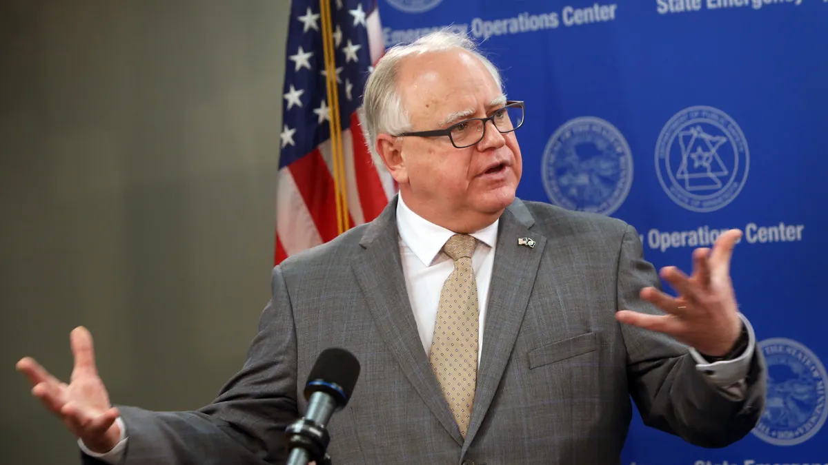 Tim Walz speaks at a podium