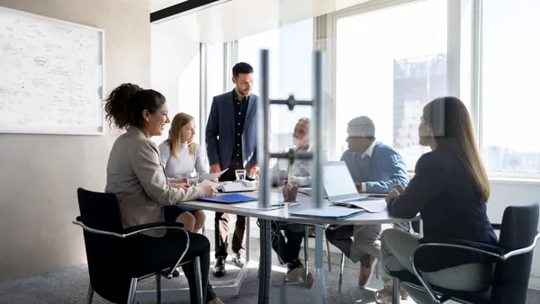 Business man talking to his team in a meeting at the office.