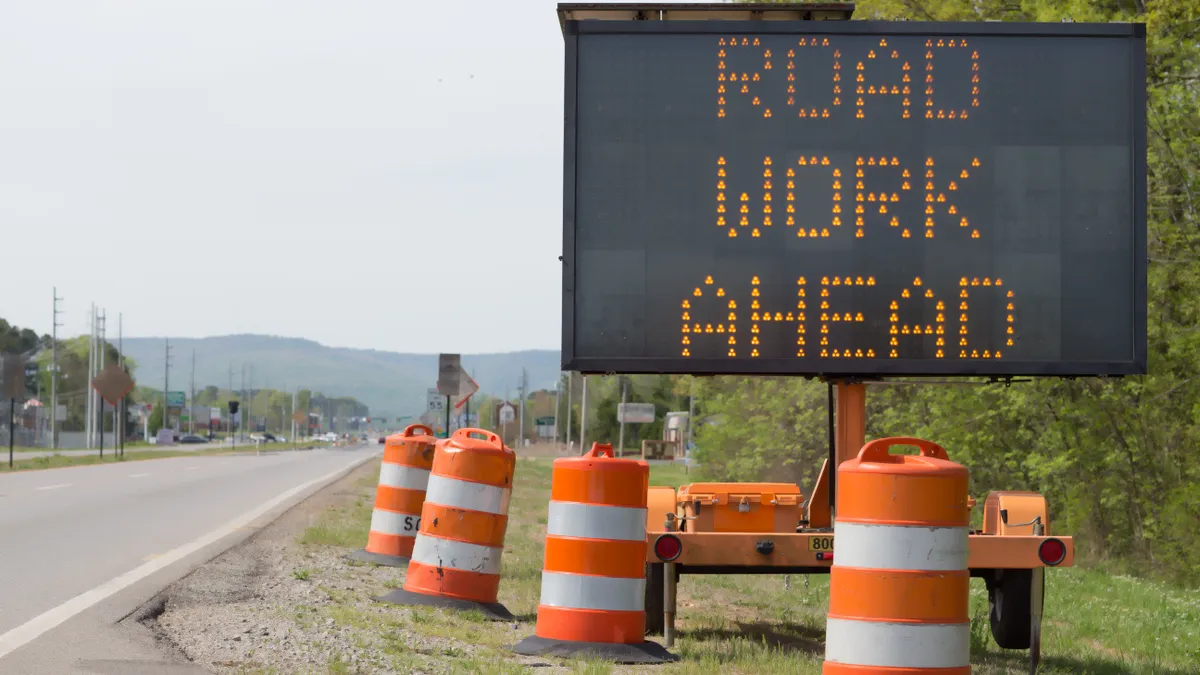 a sign on a highway indicates road work ahead