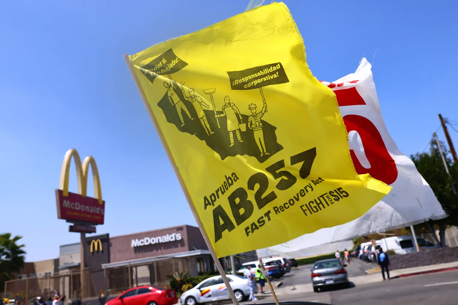 Two flags flown by fast food workers demonstrating in support of AB 257.