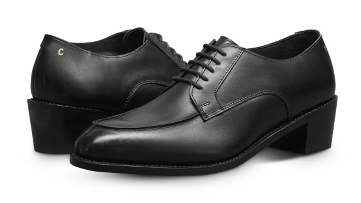 A product shot of Willy Chavarria's new shoe. It is a black oxford with a heel.